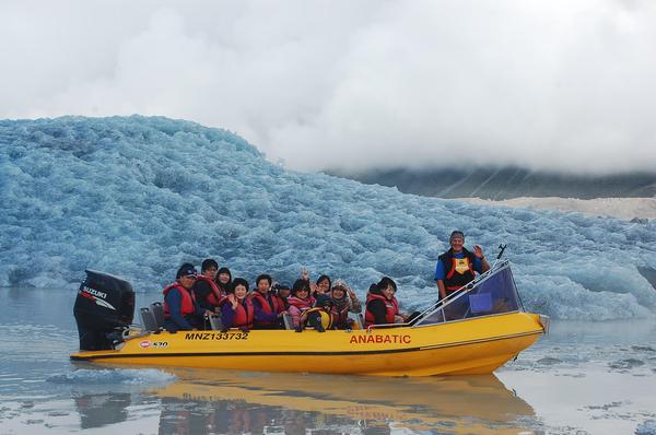 Tourists get up close and personal on a Glacier Explorers boat trip